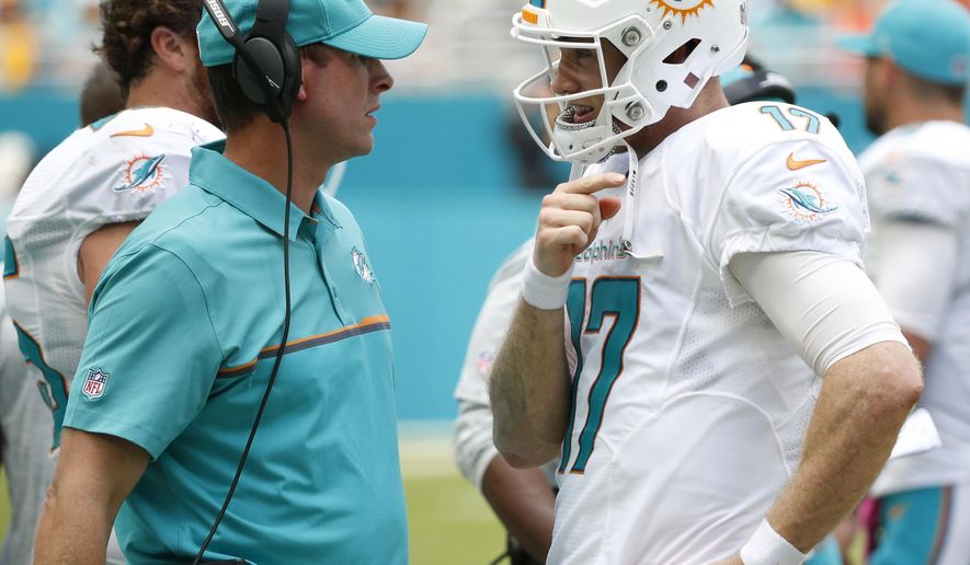 FILE - In this Oct. 16, 2016, file photo, Miami Dolphins quarterback Ryan Tannehill (17) talks to coach Adam Gase during an NFL football game against the Pittsburgh Steelers in Miami Gardens, Fla. The Miami Dolphins have been awful on the road, and that must change if they’re to make the playoffs. Two of their final three games are away from Miami, including Sunday, Dec. 16, 2018 at Minnesota, and they likely need a sweep to earn an AFC wild card berth.(AP Photo/Wilfredo Lee, File)