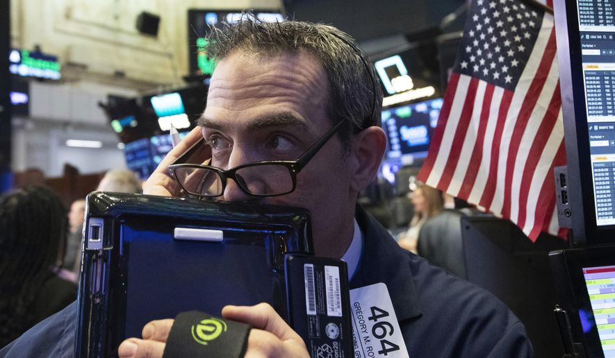 Trader Gregory Rowe works at the New York Stock Exchange, Wednesday, Dec. 12, 2018, in New York. (AP Photo/Mark Lennihan)