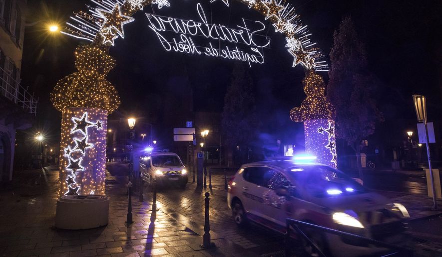 Police vehicles move at the center of the city of Strasbourg following a shooting, eastern France, Tuesday Dec. 11, 2018. A man who had been flagged as a possible extremist sprayed gunfire near the city of Strasbourg&#39;s famous Christmas market Tuesday, killing three people, wounding 12 and sparking a massive manhunt. France immediately raised its terror alert level.(AP Photo/Jean-Francois Badias)