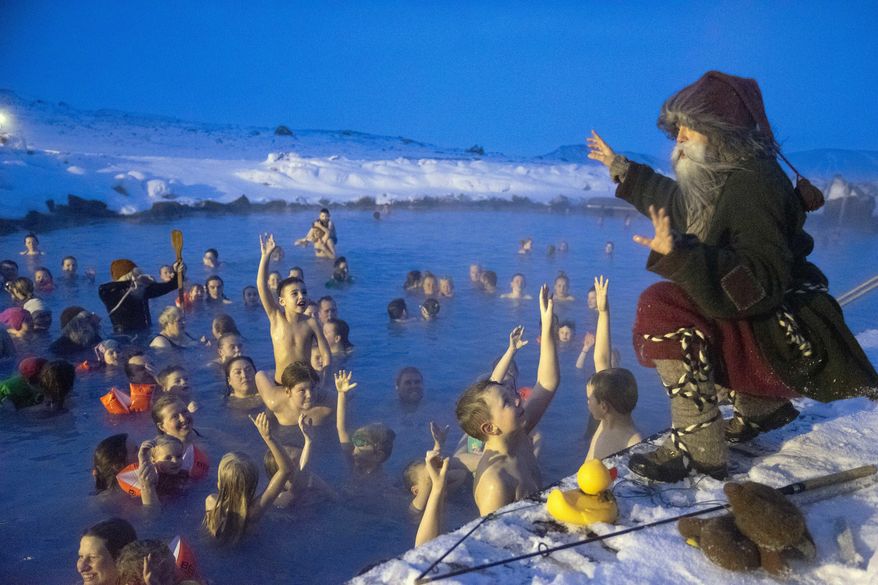 Local actor playing 'Candel-Stealer', one of Iceland's 13 mischievous troll brothers that have taken the role of Father Christmas, addresses guests at the geothermal nature lagoon by Lake Myvatn, north Iceland, Saturday Dec. 8, 2018. Instead of a friendly Santa Claus, children in Iceland enjoy favors from 13 mischievous troll brothers that arrive from the mountains thirteen days before Christmas. (AP Photo/Egill Bjarnason)