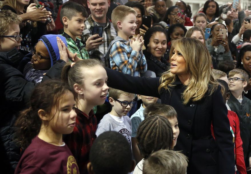 First lady Melania Trump greets children from the Burbank and Bethel Manor Elementary schools during a tour of Joint Base Langley in Hampton, Va., Wednesday, Dec. 12, 2018. (AP Photo/Steve Helber)