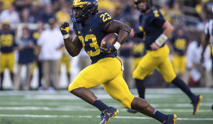 FILE - In this Sept. 15, 2018, file photo, Michigan running back O'Maury Samuels (23) rushes in the fourth quarter of an NCAA college football game against SMU, in Ann Arbor, Mich. Michigan dismissed running back O’Maury Samuels from its football program the same day he was arraigned on two charges, including one for domestic violence. The school did not say why the move was made Wednesday, Dec. 12, 2018, when Samuels was charged with domestic violence and malicious destruction of personal property. (AP Photo/Tony Ding, File)