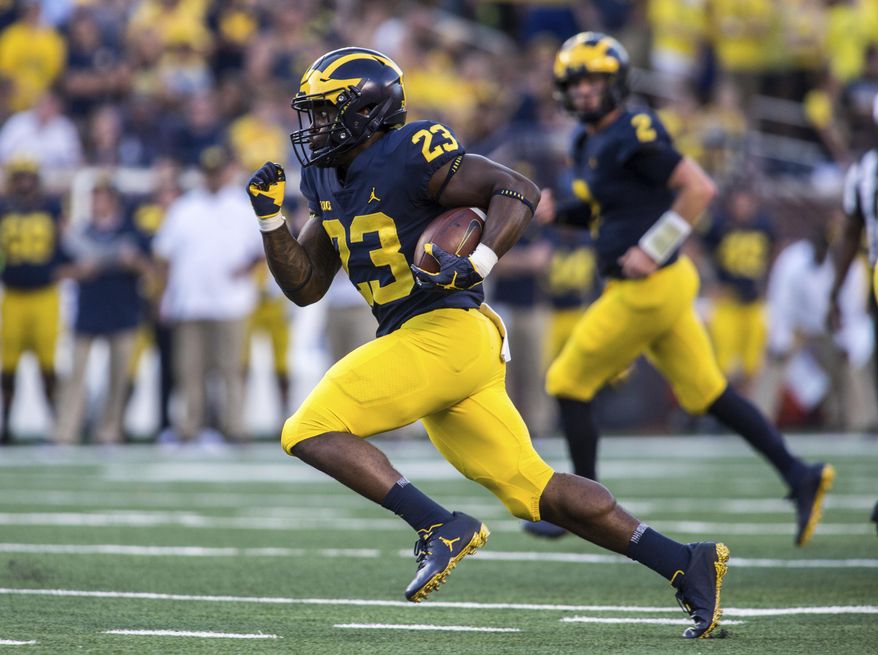 FILE - In this Sept. 15, 2018, file photo, Michigan running back O'Maury Samuels (23) rushes in the fourth quarter of an NCAA college football game against SMU, in Ann Arbor, Mich. Michigan dismissed running back O’Maury Samuels from its football program the same day he was arraigned on two charges, including one for domestic violence. The school did not say why the move was made Wednesday, Dec. 12, 2018, when Samuels was charged with domestic violence and malicious destruction of personal property. (AP Photo/Tony Ding, File)