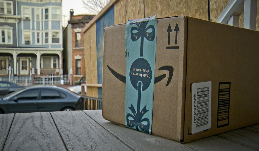 This image taken from video shows an Amazon package containing a GPS tracker on the porch of a Jersey City, N.J. residence after its delivery Tuesday, Dec. 11, 2018. The explosion in online shopping has led to porch pirates and stoop surfers swiping holiday packages from unsuspecting residents. The cops in one New Jersey city are trying to catch the thieves with some trickery of their own. (AP Photo/Robert Bumsted)