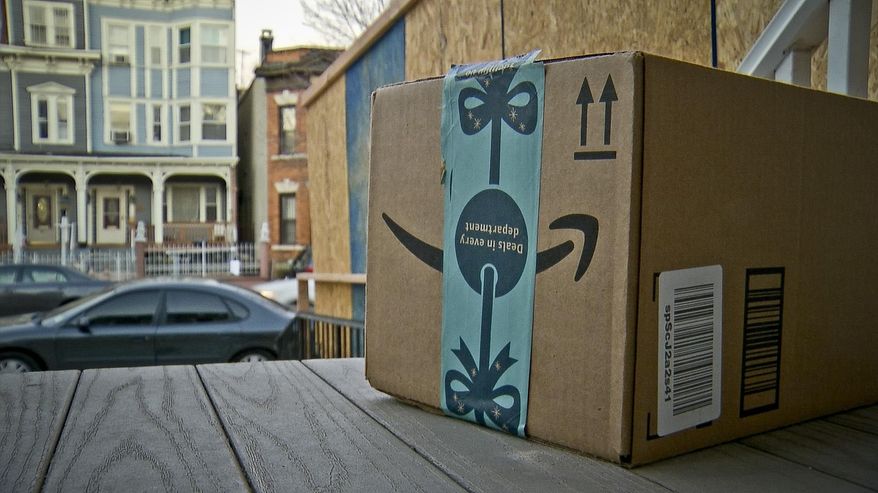 This image taken from video shows an Amazon package containing a GPS tracker on the porch of a Jersey City, N.J. residence after its delivery Tuesday, Dec. 11, 2018. The explosion in online shopping has led to porch pirates and stoop surfers swiping holiday packages from unsuspecting residents. (AP Photo/Robert Bumsted) **FILE**