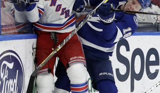 New York Rangers defenseman Kevin Shattenkirk (22) fights off a check by Tampa Bay Lightning left wing Ondrej Palat (18) during the second period of an NHL hockey game Monday, Dec. 10, 2018, in Tampa, Fla. (AP Photo/Chris O&#x27;Meara)