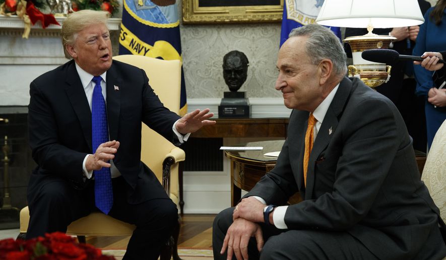 President Donald Trump speaks to Senate Minority Leader Chuck Schumer, D-N.Y., during a meeting with Democratic leadership in the Oval Office of the White House, Tuesday, Dec. 11, 2018, in Washington. (AP Photo/Evan Vucci)