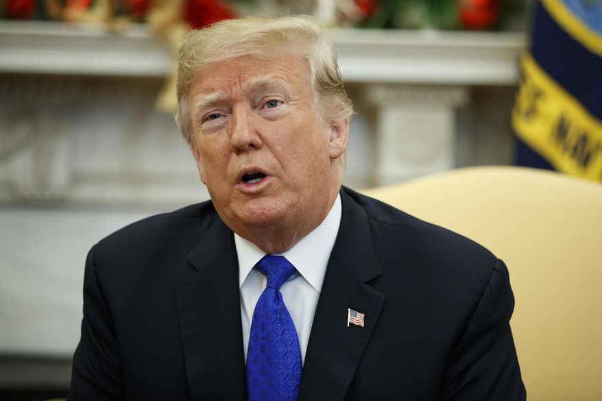 In this Dec. 11, 2018, photo, President Donald Trump speaks during a meets with Democratic leaders the Oval Office of the White House in Washington. The parent company of magazines including the National Enquirer, Us Weekly and In Touch has admitted to engaging in a journalistically dubious practice known as “catch-and-kill” in order to help Trump become president. (AP Photo/Evan Vucci)