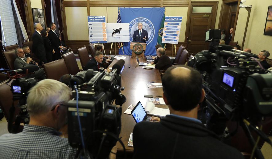 Washington Gov. Jay Inslee talks to reporters about his 2019-2021 budget proposal, Thursday, Dec. 13, 2018, at the Capitol in Olympia, Wash. (AP Photo/Ted S. Warren)