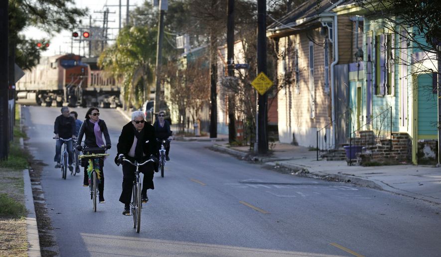 FILE - In this Feb. 13, 2015 file photo, cyclists ride along Chartres St. near the Mississippi River waterfront in the Bywater section of New Orleans. A New Orleans City Council member has released a long-awaited proposal that would ban short-term rentals of whole houses in the city&#x27;s residential areas. Thursday&#x27;s move by Kristen Gisleson Palmer drew an immediate rebuke from a spokesman from HomeAway, one of the businesses that arranges short-term vacation rentals online. (AP Photo/Gerald Herbert, File)