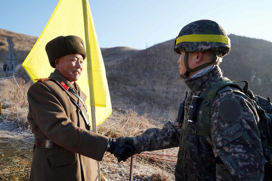 In this Wednesday, Dec. 12, 2018, file photo provided by South Korea Defense Ministry, South Korean army Col. Yun Myung-shick, right, shakes hands with North Korean army Lt. Col. Ri Jong Su before crossing the Military Demarcation Line inside the Demilitarized Zone (DMZ) to inspect the dismantled North Korean guard post in the central section of the inter-Korean border in Cheorwon. Dozens of North and South Korean soldiers crossed over the world's most heavily armed border Wednesday as they inspected the sites of their rival's front-line guard posts to verify they'd been removed, part of inter-Korean engagement efforts that come amid stalled U.S.-North Korea nuclear disarmament talks. (South Korea Defense Ministry via AP, File)