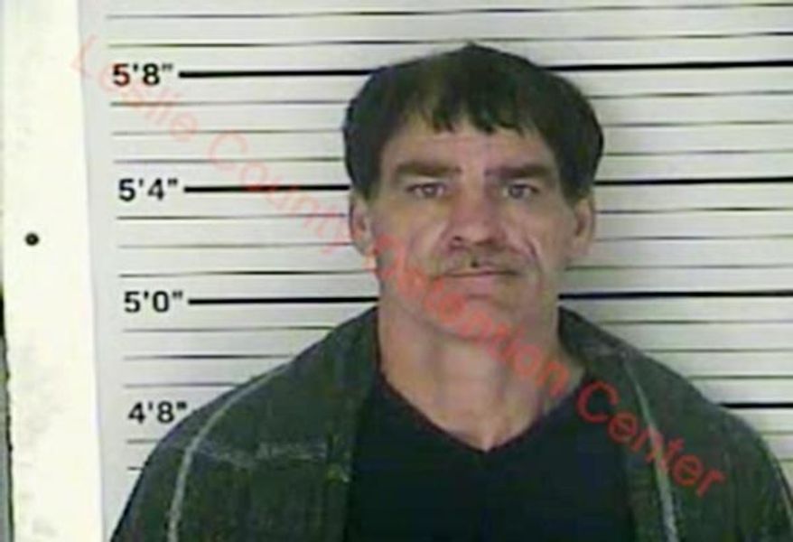 In this Wednesday, Dec. 12, 2018 photo released by the Leslie County (Ky.) Detention Center, Paul Douglas Sizemore is seen in a booking photo. Sizemore, accused of shooting at a state police trooper rushing to the scene of a triple slaying has been charged in the murders of an eastern Kentucky couple and their adult son, police said Thursday. (Leslie County Detention Center via AP)