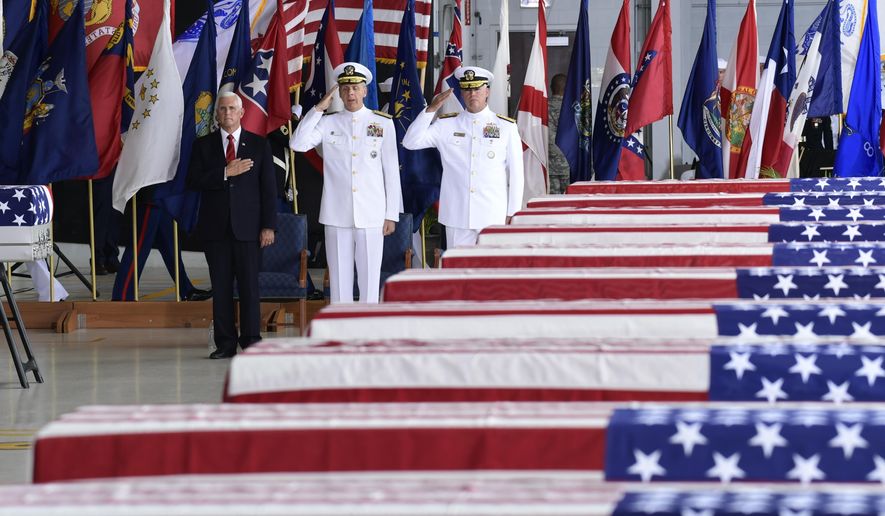 FILE - In this Aug. 1, 2018 file photo, Vice President Mike Pence, left, Commander of U.S. Indo-Pacific Command Adm. Phil Davidson, center, and Rear Adm. Jon Kreitz, deputy director of the POW/MIA Accounting Agency, attend at a ceremony marking the arrival of the remains believed to be of American service members who fell in the Korean War at Joint Base Pearl Harbor-Hickam, Hawaii, Wednesday, Aug. 1, 2018. North Korea handed over the remains. Pentagon officials say they have been unable so far to draw North Korea into negotiations on returning additional remains of Americans killed in North Korea.  (AP Photo/Susan Walsh)