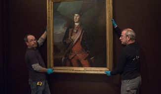 Dermot Rooney, left, and David Schlaegel prepare to install George Washington&#39;s Peale portrait, on loan from Washington &amp;amp; Lee University, in the Donald W. Reynolds Museum at Mount Vernon on Thursday, Dec. 13, 2018 in Mount Vernon, Va. (AP Photo/Kevin Wolf)