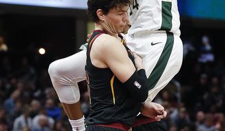 Milwaukee Bucks&#39; Giannis Antetokounmpo (34), from Greece, goes up to shoot against Cleveland Cavaliers&#39; Cedi Osman (16), from Turkey, during the first half of an NBA basketball game Friday, Dec. 14, 2018, in Cleveland. (AP Photo/Ron Schwane)