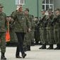 Kosovo president Hashim Thaci, center, flanked by KSF Commander Rrahman Rama as they inspect members of Kosovo Security Force in capital Pristina, Kosovo, on Thursday, Dec. 13, 2018. Kosovo lawmakers are set to transform the Kosovo Security Force into a regular army, a move that significantly heightened tension with neighboring Serbia. (AP Photo/Visar Kryeziu)
