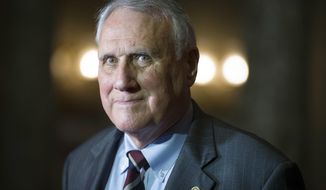 FILE - In this Sept. 5, 2018, photo, Sen. Jon Kyl, R-Ariz., waits to be sworn in as a U.S. Senator by Vice President Mike Pence in at the Old Senate Chamber on Capitol Hill in Washington.  Arizona Gov. Doug Ducey announced Friday, Dec. 14,  Kyl will resign at the end of the year from the U.S. Senate seat he was appointed to less than four months ago following the death of Sen. Jon McCain. (AP Photo/Cliff Owen, File)