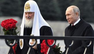 In this file photo from Nov. 4, 2018, Russian President Vladimir Putin and Russian Orthodox Church Patriarch Kirill, left, walk to lay flowers at the monument of Minin and Pozharsky at Red Square in Moscow, during National Unity Day. The Russian Church said on Friday, Dec. 14, 2018, that Patriarch Kirill has sent a letter to the U.N. secretary-general, German Chancellor Angela Merkel, French President Emmanuel Macron, Pope Francis, the Archbishop of Canterbury and other spiritual leaders, urging them to help protect the clerics, believers and their faith in Ukraine. (Alexander Nemenov/Pool Photo via AP, File)