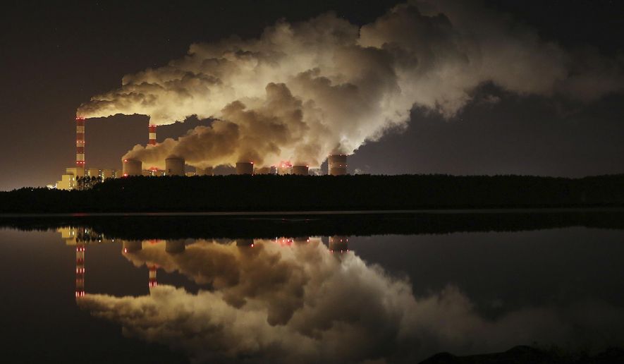 FILE - In this Wednesday, Nov. 28, 2018 file photo, plumes of smoke rise from Europe&#x27;s largest lignite power plant in Belchatow, central Poland. As politicians haggle at a U.N. climate conference in Poland over ways to limit global warming, the industries and machines powering our modern world keep spewing their pollution into the air and water. The fossil fuels extracted from beneath the earth’s crust _ coal, oil and gas _ are transformed into the carbon dioxide that is now heating the earth faster than scientists had expected even a few years ago. (AP Photo/Czarek Sokolowski)