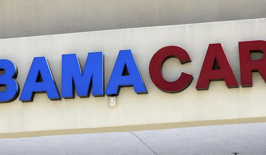 File- This May 11, 2017, file photo shows an Obamacare sign being displayed on the storefront of an insurance agency in Hialeah, Fla. A conservative federal judge in Texas on Friday, Dec. 14, 2018, ruled the Affordable Care Act “invalid” on the eve of the sign-up deadline for next year. But with appeals certain, even the Trump White House said the law will remain in place for now. In a 55-page opinion, U.S. District Judge Reed O’Connor ruled Friday that last year’s tax cut bill knocked the constitutional foundation from under “Obamacare” by eliminating a penalty for not having coverage. The rest of the law cannot be separated from that provision and is therefore invalid, he wrote. (AP Photo/Alan Diaz, File)