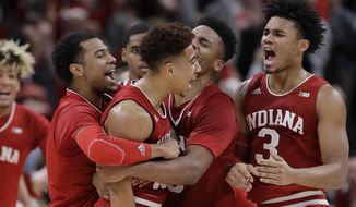 Indiana&#39;s Rob Phinisee, middle, celebrates after hitting the game winning shot as time expired during an NCAA college basketball game against Butler, Saturday, Dec. 15, 2018, in Indianapolis. Indiana won 71-68. (AP Photo/Darron Cummings)