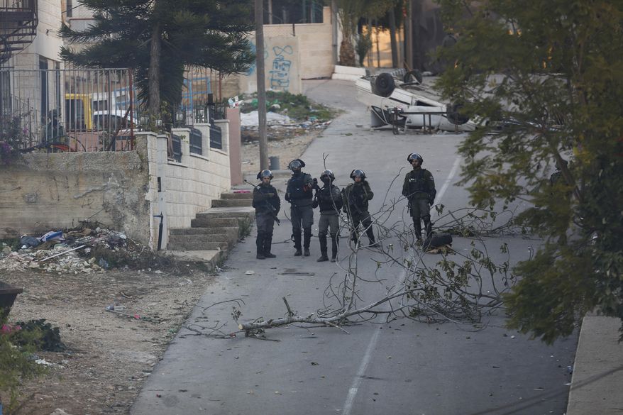 Israeli forces block the road during the demolition Abu Humaid family house, in the West Bank city of Ramallah, Saturday, Dec. 15, 2018. Islalm Yousef Abu Humaid is accused of killing aIsraeli soldier by dropping a slab from a roof during a raid last May. (AP Photo/Majdi Mohammed)