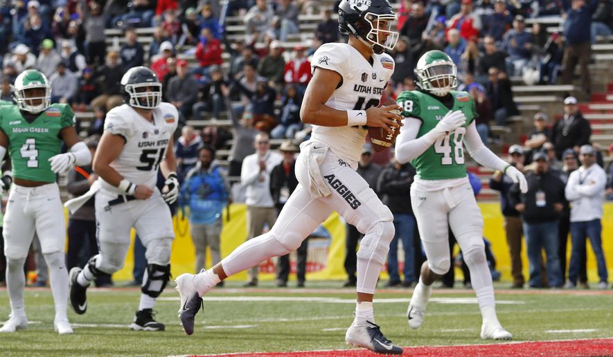 Utah State quarterback Jordan Love (10) scores a touchdown against North Texas during the first half of the New Mexico Bowl NCAA college football game in Albuquerque, N.M., Saturday, Dec. 15, 2018. (AP Photo/Andres Leighton)