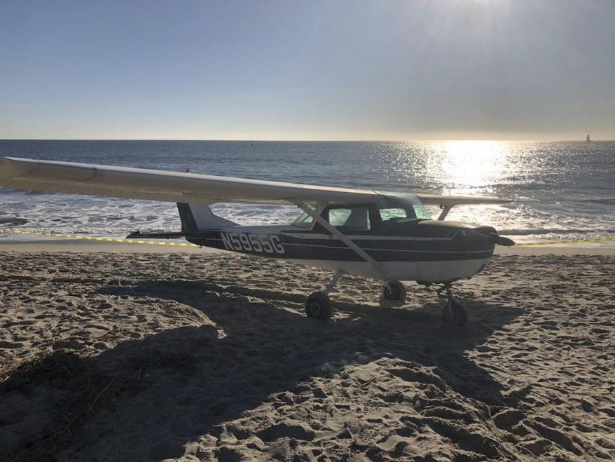 In this photo released by the Orange County Fire Authority, (OCFA), a small airplane that touched down on Doheny State Beach is seen in the sand Saturday, Dec. 15, 2018, in Dana Point, Calif. The small-engine plane made an emergency landing on a Southern California beach but no one aboard or on the ground was hurt. The OCFA says the Cessna airplane touched down on the beach Saturday afternoon, on an empty stretch of sand, away from beachgoers. (Fire Capt. Tony Bommarito/OCFA via AP)