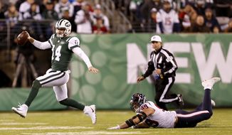 New York Jets quarterback Sam Darnold (14) avoids a hit from Houston Texans defensive end J.J. Watt (99) during the second half of an NFL football game, Saturday, Dec. 15, 2018, in East Rutherford, N.J. (AP Photo/Adam Hunger)