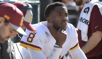 Washington Redskins quarterback Josh Johnson (8) watches play as he takes a break on the bench during the first half of an NFL football game against the Jacksonville Jaguars, Sunday, Dec. 16, 2018, in Jacksonville, Fla. (AP Photo/Phelan M. Ebenhack) **FILE**
