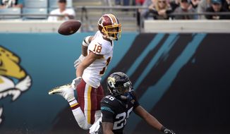 Jacksonville Jaguars defensive back Jarrod Wilson, right, breaks up a pass intended for Washington Redskins wide receiver Josh Doctson (18) during the first half of an NFL football game, Sunday, Dec. 16, 2018, in Jacksonville, Fla. (AP Photo/Phelan M. Ebenhack) **FILE**