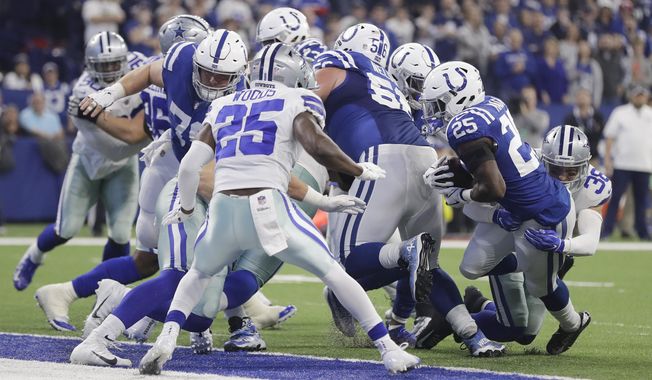 Indianapolis Colts running back Marlon Mack (25) scores a touchdown while being tackled by Dallas Cowboys strong safety Jeff Heath (38) during the first half of an NFL football game, Sunday, Dec. 16, 2018, in Indianapolis. (AP Photo/Darron Cummings)