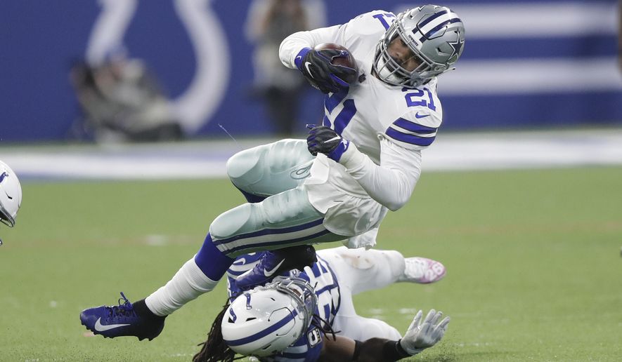 Dallas Cowboys' Ezekiel Elliott (21) is tackled by Indianapolis Colts' Clayton Geathers (26) during the second half of an NFL football game, Sunday, Dec. 16, 2018, in Indianapolis. (AP Photo/Michael Conroy)