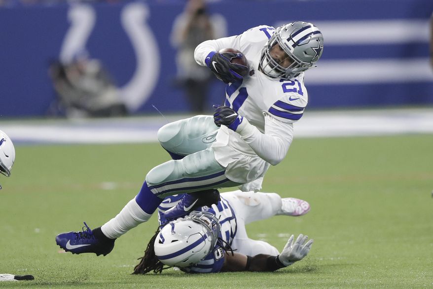 Dallas Cowboys' Ezekiel Elliott (21) is tackled by Indianapolis Colts' Clayton Geathers (26) during the second half of an NFL football game, Sunday, Dec. 16, 2018, in Indianapolis. (AP Photo/Michael Conroy)