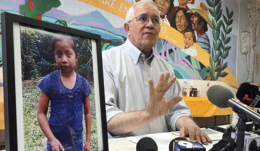 Annunciation House director Ruben Garcia answers questions from the media after reading a statement from the family of Jakelin Caal Maquin, pictured at left, during a press briefing at Casa Vides, Saturday, Dec. 15, 2018, in downtown El Paso, Texas. Maquin had received her first pair of shoes several weeks ago, when her father said they would set out together for the U.S., thousands of miles from her impoverished Guatemalan village. Instead she died in a Texas hospital two days after being taken into custody by U.S. Border Patrol agents in a remote stretch of New Mexico desert. (Rudy Gutierrez/The El Paso Times via AP) **FILE**