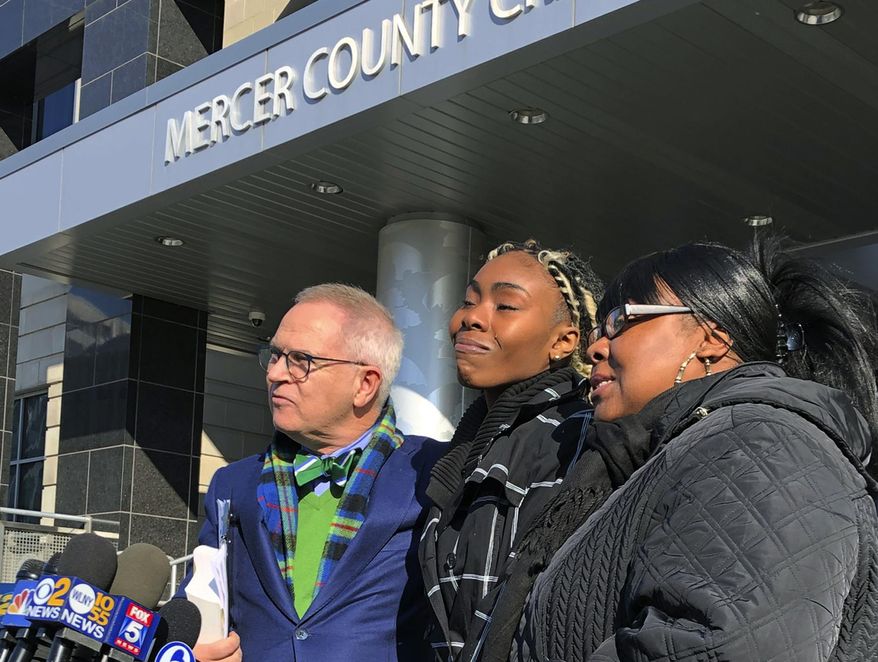 FILE - In this Dec. 12, 2018, file photo, Jazmine Headley, center, joins attorney Brian Neary and her mother, Jacqueline Jenkins, outside a courthouse in Trenton, N.J., after she accepted a deal to enter a pretrial intervention program related to credit card theft charges she faced. Headley, who had her toddler yanked from her arms by New York police in a widely seen video said in an interview published on Sunday that she went into "defense mode." (AP Photo/Mike Catalini, File)