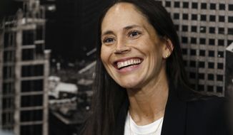 Sue Bird jokes with reporters as she talks about her new role as basketball operations assistant for the Denver Nuggets before an NBA basketball game Sunday, Dec. 16, 2018, in Denver. (AP Photo/David Zalubowski)