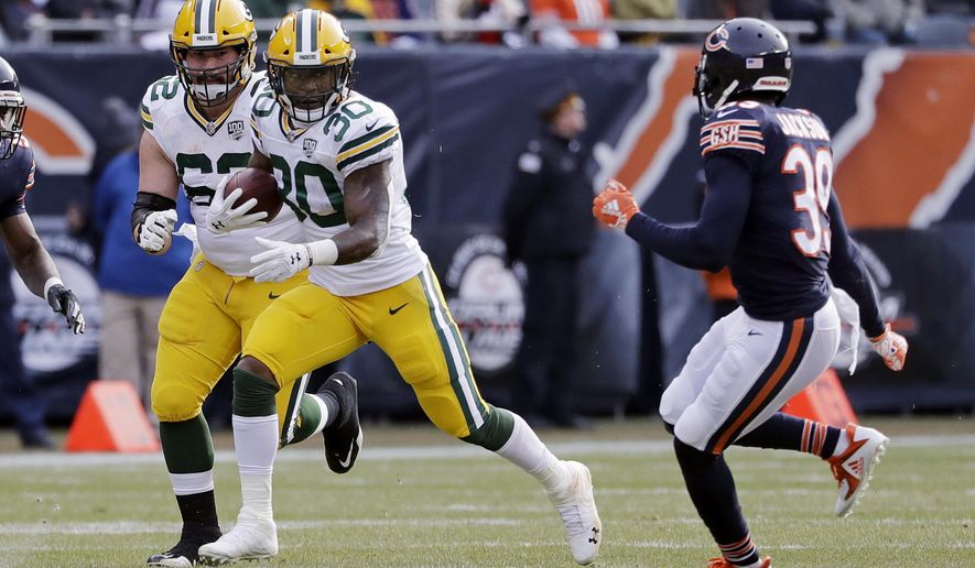 Green Bay Packers running back Jamaal Williams (30) runs against Chicago Bears defensive back Eddie Jackson (39) during the first half of an NFL football game against the Chicago Bears Sunday, Dec. 16, 2018, in Chicago. (AP Photo/Nam Y. Huh)