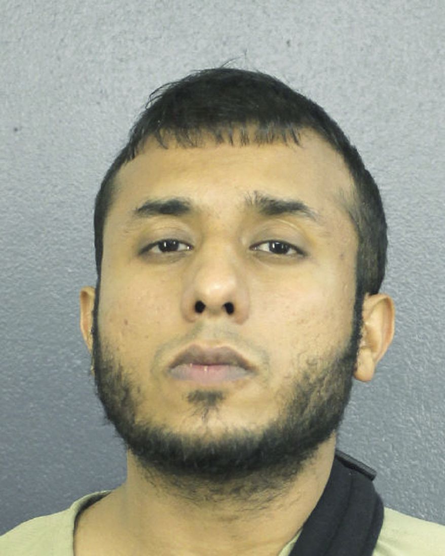 This Dec. 14, 2018 photo made available by the Broward County Sheriff's Office, Fla., shows Tayyab Tahir Ismail under arrest. An FBI affidavit unsealed Monday, Dec. 17, 2018, charges Ismail with posting detailed bomb-making instructions to online sites frequented by extremists such as supporters of the Islamic State group. (Broward County Sheriff's Office via AP)