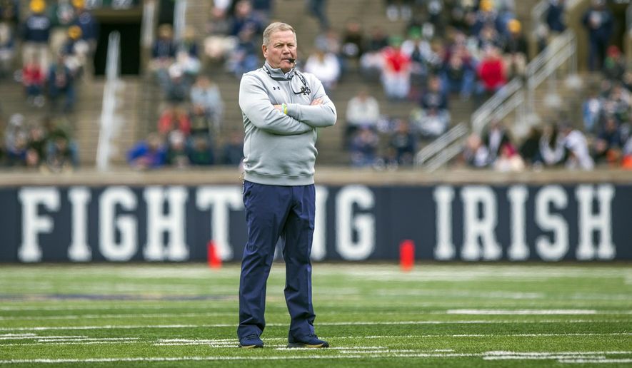 FILE - In this April 21, 2018, file photo, Notre Dame head coach Brian Kelly watches during the Notre Dame Blue-Gold Spring college football game in South Bend, Ind. Brian Kelly is The Associated Press college football Coach of the Year, Monday, Dec. 17, 2018, becoming the third coach to win the award twice since it was established in 1998. (Robert Franklin/South Bend Tribune via AP, File)