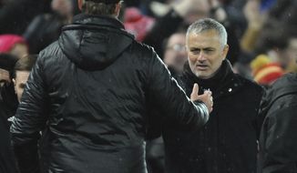 Liverpool manager Juergen Klopp, left, and Manchester United manager Jose Mourinho shake hands after the English Premier League soccer match between Liverpool and Manchester United at Anfield in Liverpool, England, Sunday, Dec. 16, 2018. (AP Photo/Rui Vieira)