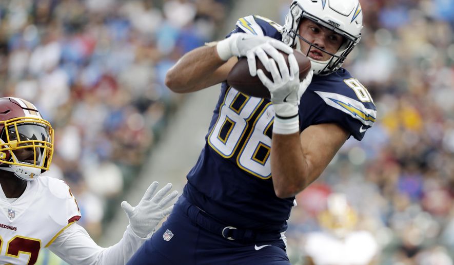 FILE - In this Sunday, Dec. 10, 2017 file photo, Los Angeles Chargers tight end Hunter Henry makes a touchdown catch during the first half of an NFL football game as Washington Redskins safety Deshazor Everett looks on in Carson, Calif. Chargers tight end Hunter Henry took part in his first practice on Monday, Dec. 17, 2018 nearly seven months after tearing the anterior cruciate ligament in his right knee. (AP Photo/Alex Gallardo, file)