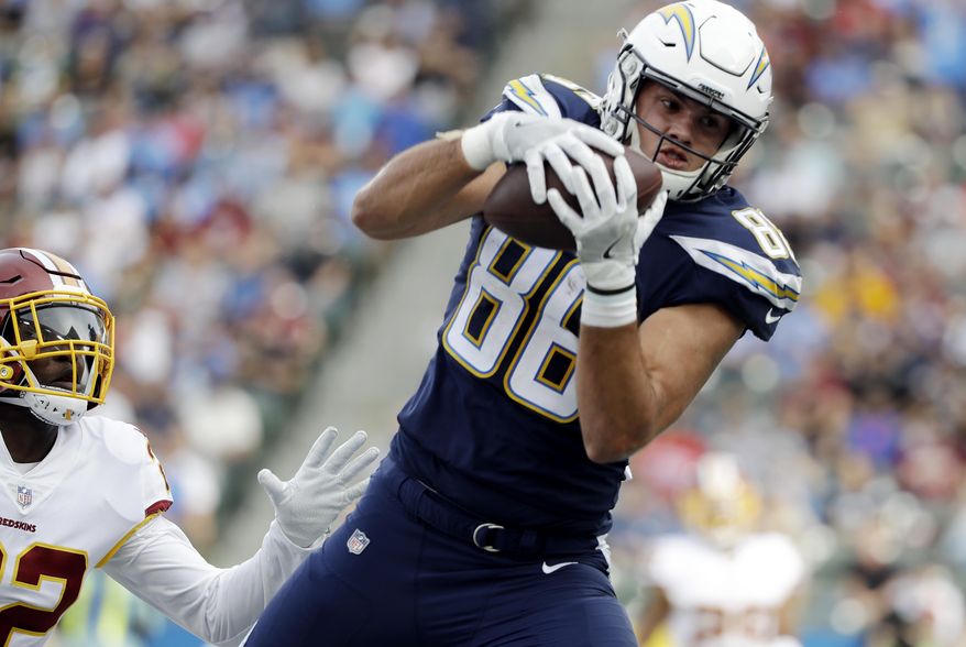 FILE - In this Sunday, Dec. 10, 2017 file photo, Los Angeles Chargers tight end Hunter Henry makes a touchdown catch during the first half of an NFL football game as Washington Redskins safety Deshazor Everett looks on in Carson, Calif. Chargers tight end Hunter Henry took part in his first practice on Monday, Dec. 17, 2018 nearly seven months after tearing the anterior cruciate ligament in his right knee. (AP Photo/Alex Gallardo, file)