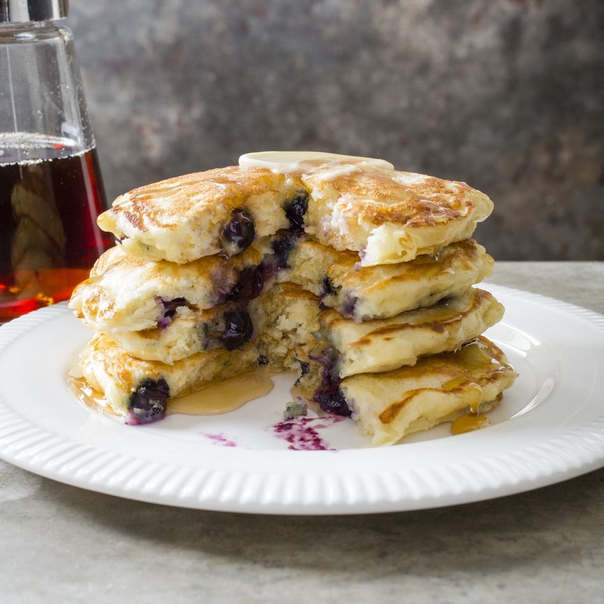 This undated photo provided by America's Test Kitchen in December 2018 shows Blueberry Pancakes in Brookline, Mass. This recipe appears in the "Complete Cookbook for Young Chefs." (Carl Tremblay/America's Test Kitchen via AP)