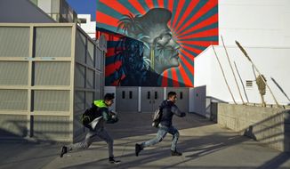 A mural by artist Beau Stanton of actress Ava Gardner is seen at the Robert F. Kennedy Community Schools complex school in Los Angeles Thursday, Dec. 13, 2018. Protesters say the mural suggests the Japanese imperial battle flag, a symbol that offends Korean groups. The artist, Beau Stanton, denies any connection. The L.A. School District has agreed to paint over the mural during the winter break, said Roberto Martinez, the senior school district administrator for that region, according to a report by the Los Angeles Times. (AP Photo/Damian Dovarganes)