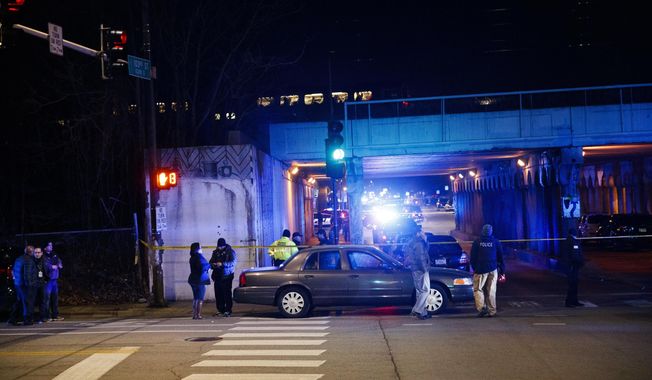 Police investigate the scene where two officers were killed after they were struck by a South Shore train near 103rd Street and Dauphin Avenue on Monday, Dec. 17, 2018, in Chicago. Police spokesman Anthony Guglielmi posted on Twitter that the &amp;quot;devastating tragedy&amp;quot; occurred when the officers were investigating a shots-fired call. (Armando L. Sanchez/Chicago Tribune via AP)