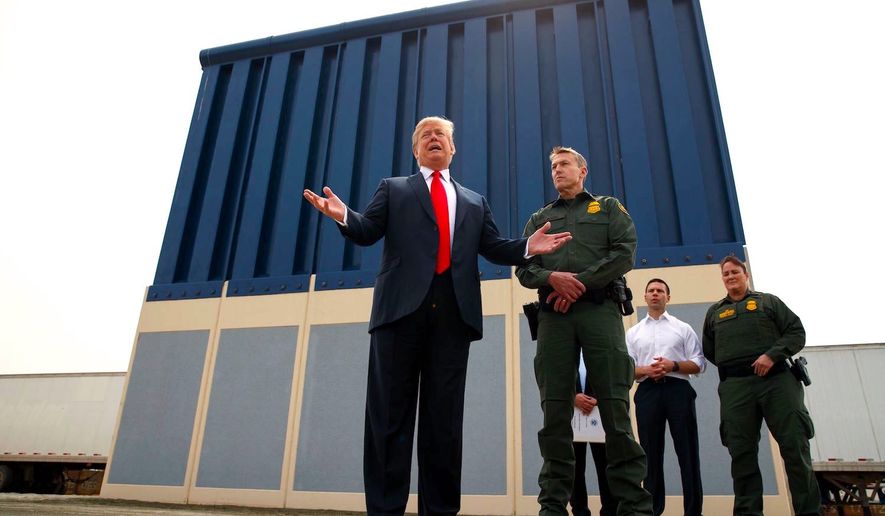 President Trump joins Border Patrol San Diego sector chief Rodney Scott before a prototype unit of the border wall just outside San Diego. (Associated Press)