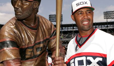 Chicago White Sox first base coach Harold Baines poses with his life-sized sculpture during a ceremony before their baseball game against the Kansas City Royals, Sunday, July 20, 2008, in Chicago.(AP Photo/Nam Y. Huh)
