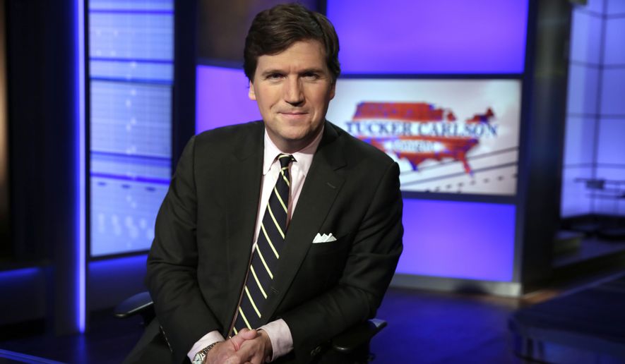 Tucker Carlson, host of &quot;Tucker Carlson Tonight,&quot; poses for photos in a Fox News Channel studio, in New York, Thursday, March 2, 2107. (AP Photo/Richard Drew)