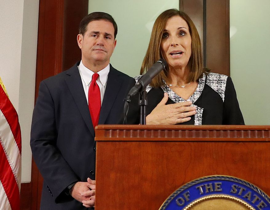U.S. Rep. Martha McSally, R-Ariz., speaks, during a news conference Tuesday, Dec. 18, 2018, at the Capitol in Phoenix, after Arizona Gov. Doug Ducey, rear, announced his decision to replace U.S. Sen. Jon Kyl, R-Ariz. with McSally in the U.S. Senate seat that belonged to Sen. John McCain. McSally will take over after Kyl&#39;s resignation becomes effective Dec. 31. (AP Photo/Matt York)